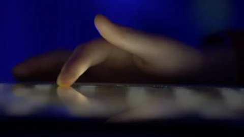 Girl Browsing Digital Tablet Computer With Finger at Night. Person Using Sm.. Stock Footage 312814902
