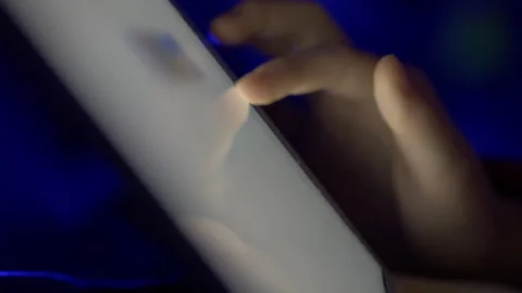 Girl Browsing Digital Tablet Computer With Finger at Night. Person Using Sm.. Stock Footage 329450321