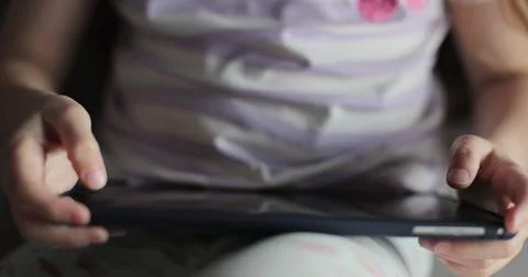 Girl browsing digital tablet computer. Close-up finger scrolling social media 스톡 사진