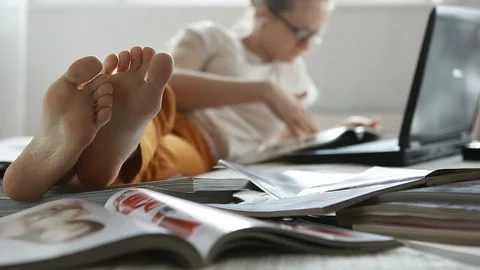 Girl browsing magazines Stock Footage 85927911