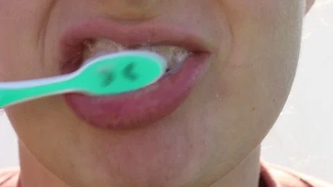 Girl brushing teeth with paste front view close-up. Stock Footage 122190052