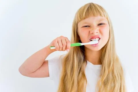 Girl brushing teeth Stock Photos