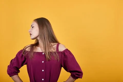 Girl in burgundy bluse with bow suffering from backache of having made an effort Stock Photos