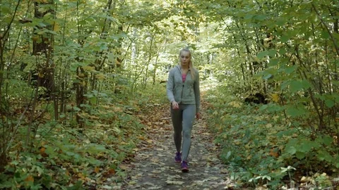 The girl buttoned up on the jacket, put the hood on her head and started running Stock Footage 81690322