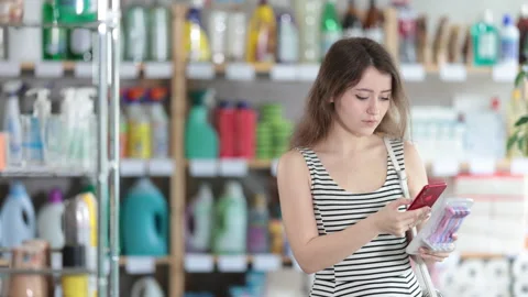 Girl buyer scans qr code on razor label Stock Footage 311840319