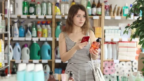Girl buyer scans qr code on liquid hand soap label Stock Footage 328140328