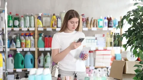 Girl buyer scans qr code on razor kit label Stock Footage 329394897