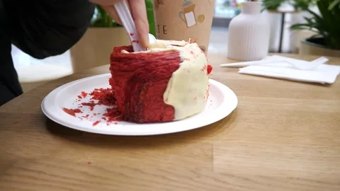 A girl in a cafe cuts and  eats a dessert in slow motion Stock Footage 291870602