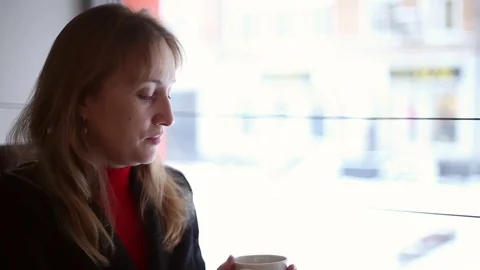 The girl in the cafe drinking tea Stock Footage 70278249