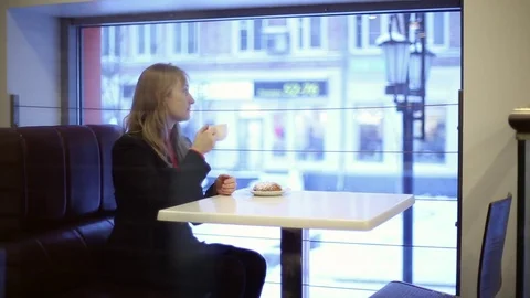 The girl in the cafe drinking tea Stock Footage 70283050