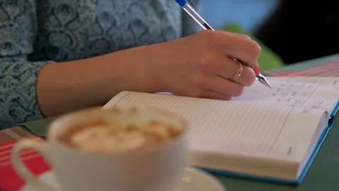 The girl in the cafe takes notes in a notebook Stock Footage 71962847