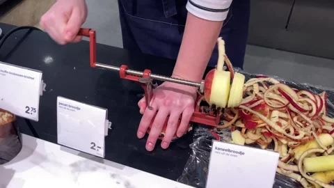 Girl at cafe using apple peeling machine on red apple 動画素材 268255847