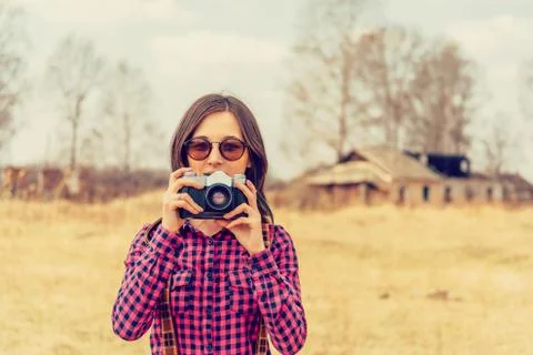 Girl with camera Stock Photos