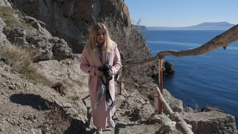 Girl with a camera rises up Stock Footage 105792014