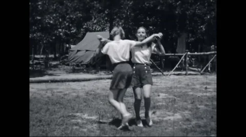 Girl campers dancing at campsite Stock Footage