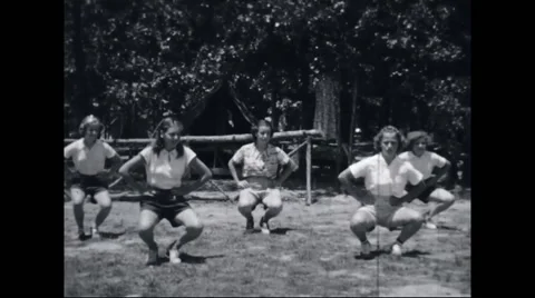 Girl campers exercising at campsite Stock Footage