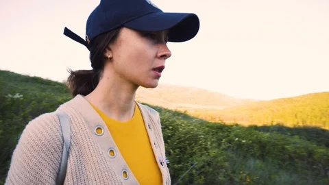 The girl in the cap is on a mountain path Stock Footage 111570391