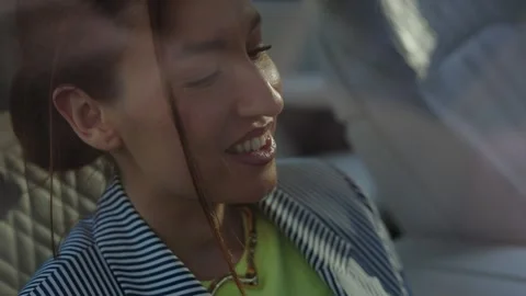 Girl in car using smartphone, looking at phone, girl smiling Stock Footage 305993028