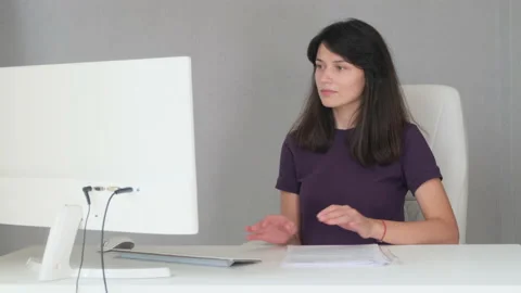 The girl carefully examines the documents at the table Stock Footage 136588497