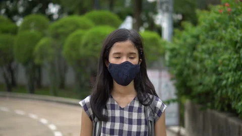 Girl Casually Walking in Park While Wearing Face Mask - New Normal Post Covid-19 Stock Footage 133019154