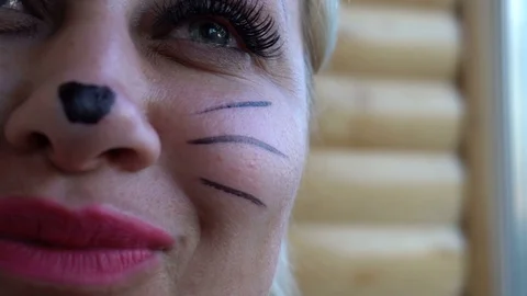 Girl with cat make-up, close-up shooting Stock Footage 76478490
