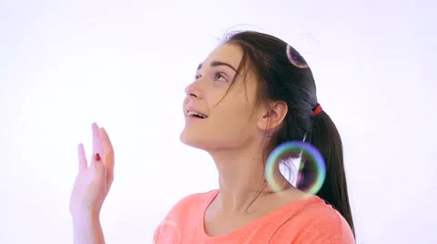 Girl Catching Bubbles in studio Stock Footage 59133843