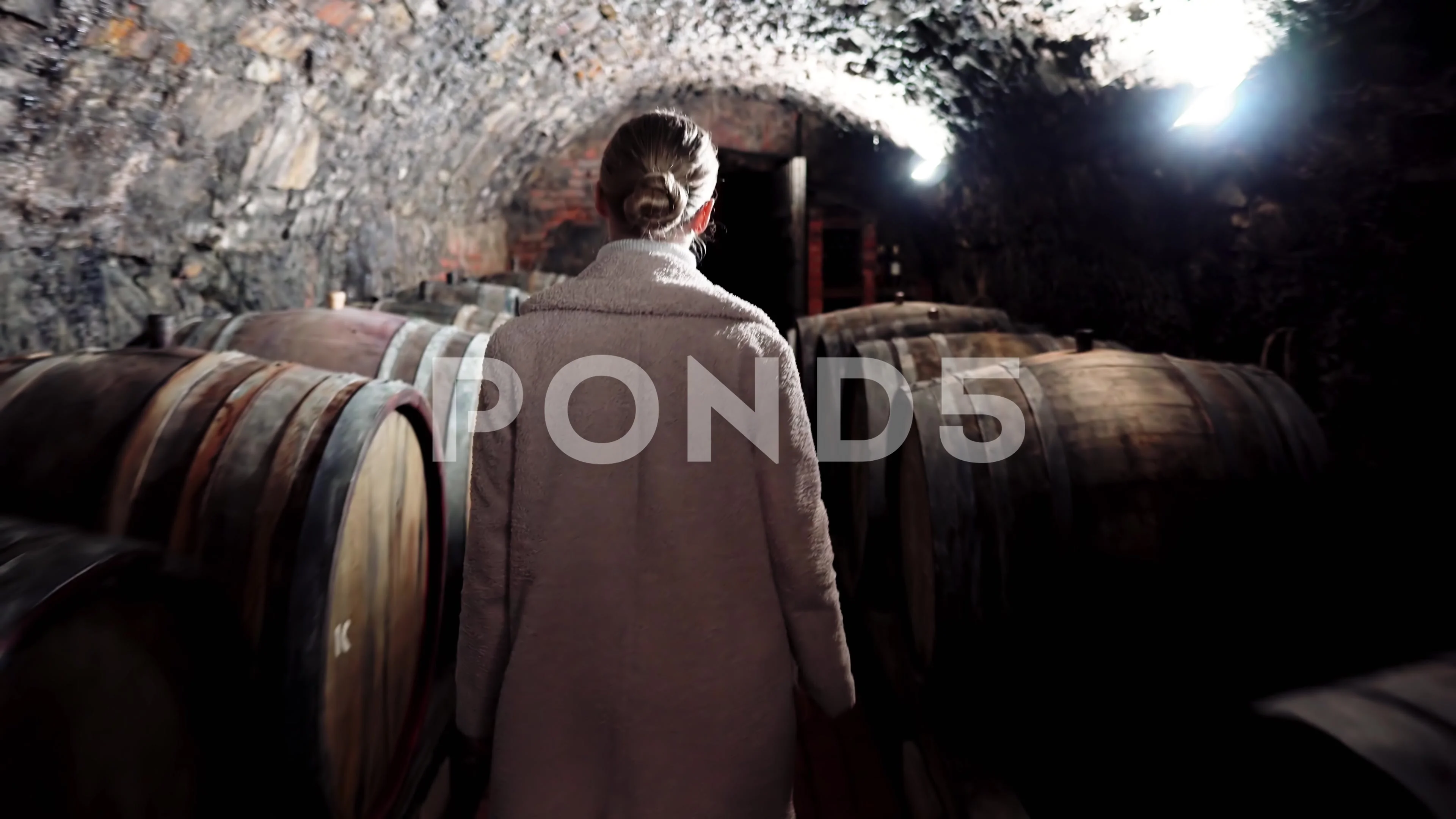 Girl in the cellar with wine in oak barr, Stock Video