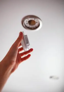 The girl changes the light bulb in the stretch ceiling Stock Photos