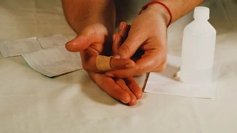 The girl changes the patch on her finger, close-up Stock Footage 108054608