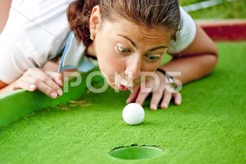 Girl cheating in the game of golf Stock Photos