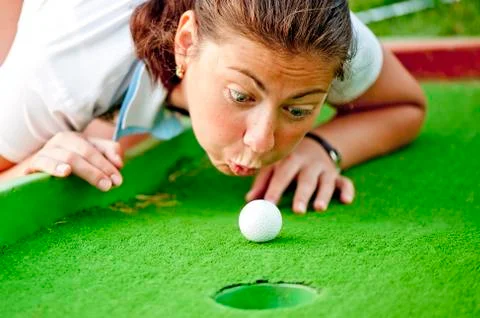 Girl cheating in the game of golf Stock Photos