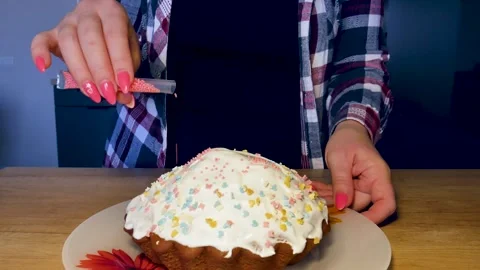 Girl in checkered shirt decorating easter cupcake with white sugar icing wi.. Stock Footage 312318814
