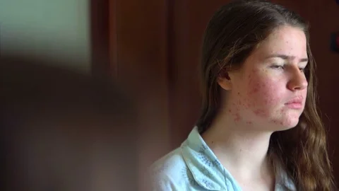 Girl checking her face in the mirror Stock Footage 73754489