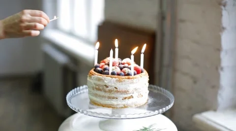 Girl chef decorates biscuit cake with fresh strawberries blueberries Stock Footage