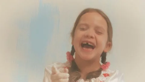 Girl chef without teeth blows to handful flour. Point fingersand laughs Stock Footage 140746281