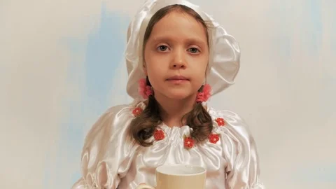 Girl chef without teeth drinking milk, licking lips and white mustache laughing. Stock Footage 74171931