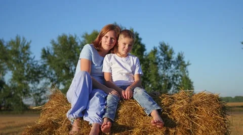 A girl with a child resting on a haystack Video stock 67381391