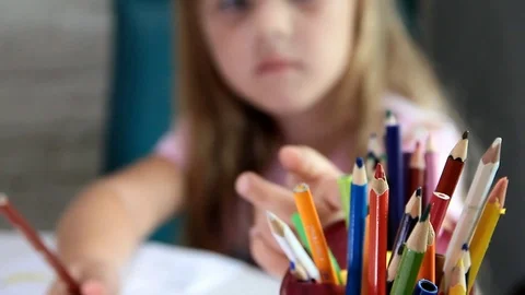 Girl chooses pencils in stand Stock Footage 123745954