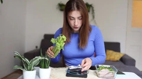 Girl choosing between celery and chocolate Video stock 341235868