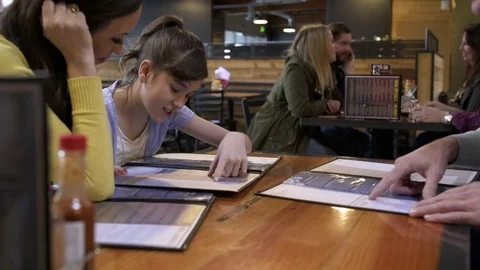 Girl choosing from a menu Stock Footage 77079104
