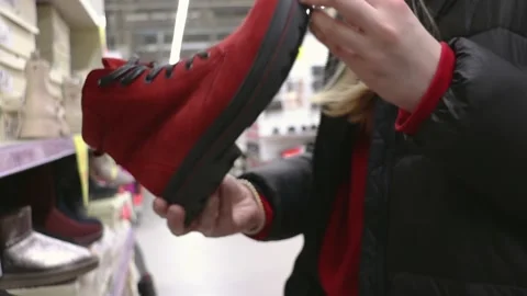 Girl choosing shoes in the store Stock Footage 236496653