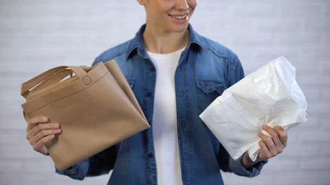 Girl choosing trendy ecobag instead plastic package, pollution with polyethylene Vídeos de archivo 106684195