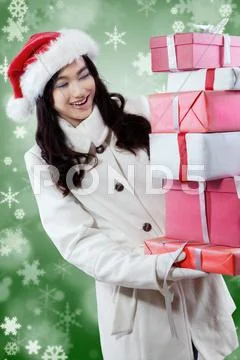 Girl with christmas gift and winter background Stock Photos