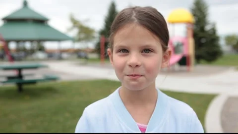 Girl chuckles on playground Stock Footage 5504518