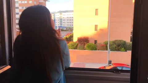 Girl clapping from the window. People clapping on balconies and windows in su Stock Footage 130070971