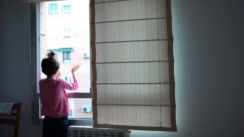 Girl clapping in the window in support of people against the coronavirus Stock Footage 128313438