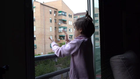 Girl clapping in the window in support of people against the coronavirus Stock Footage 128765191