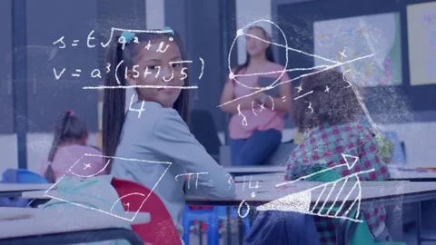 Girl in class writing while chalk math overlays appearing, turning to camera, Stock Footage 334351988