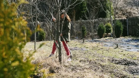 Girl cleans grass rake Video stock 105378312