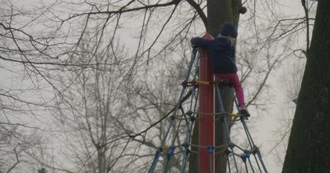 Girl Climbed on Top of Column on a Rope Ladder Stock Footage 61908132